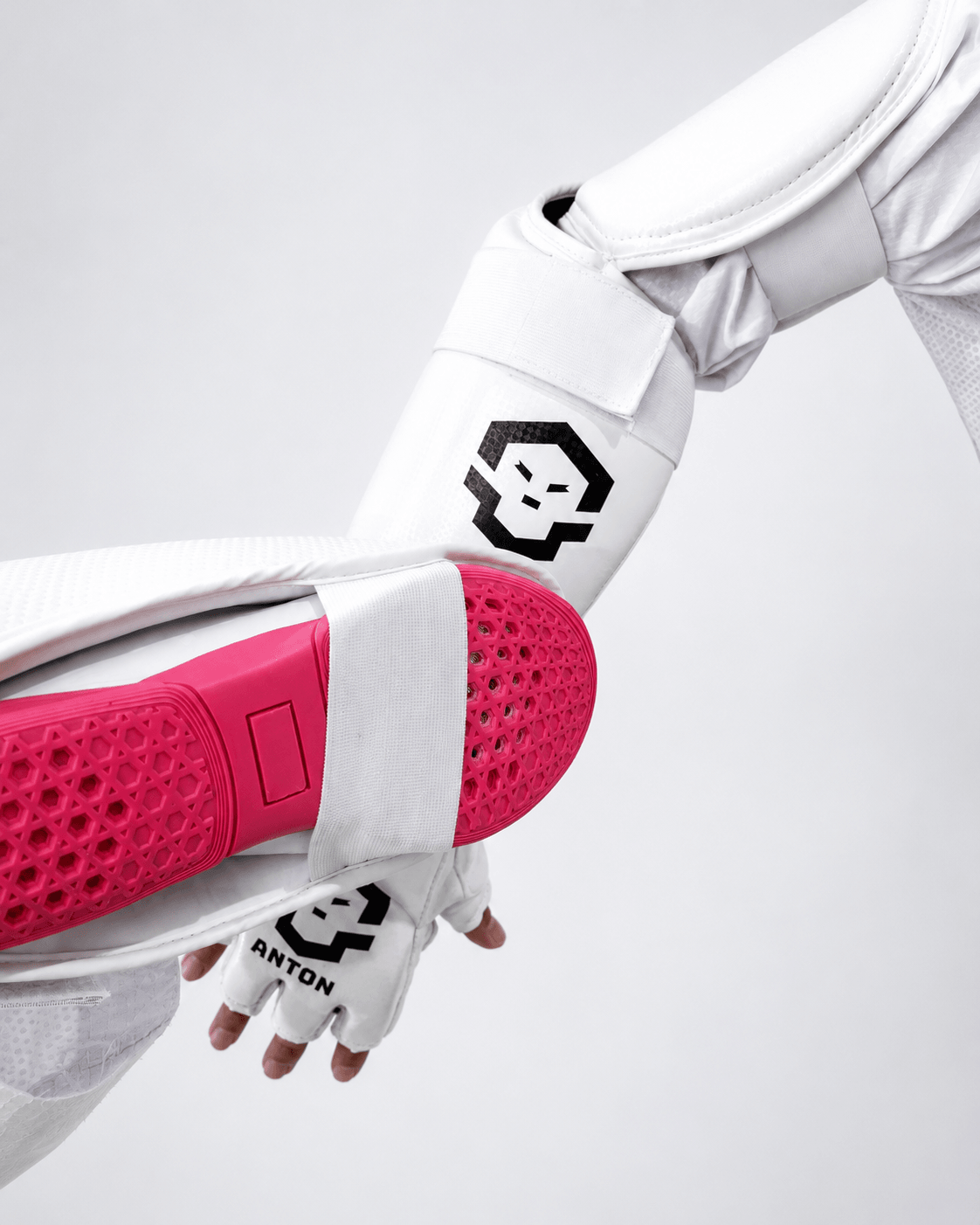 Arm Ultra blocking a pink training pad - Anton Core padding absorbing direct impact
