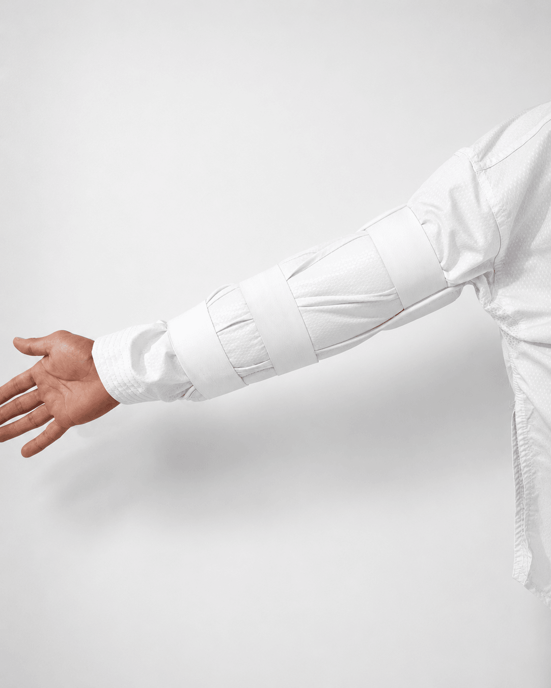 Standard arm guard worn on an extended arm - padding covers only part of the forearm, leaving the inner surface exposed