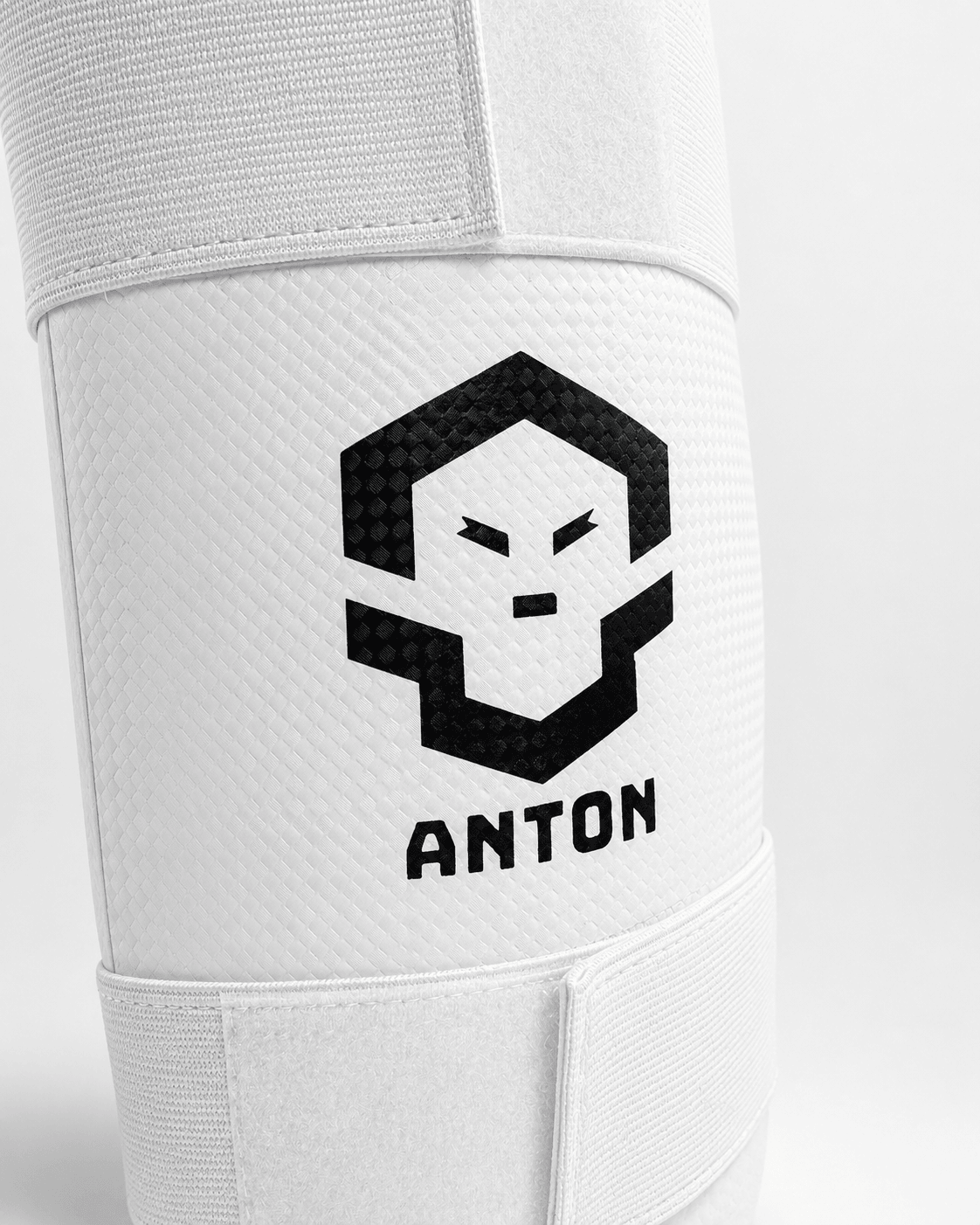 Anton Leg Ultra shin guard - carbon-textured shell face and Anton mark, the shell over the two-layer Anton Core padding